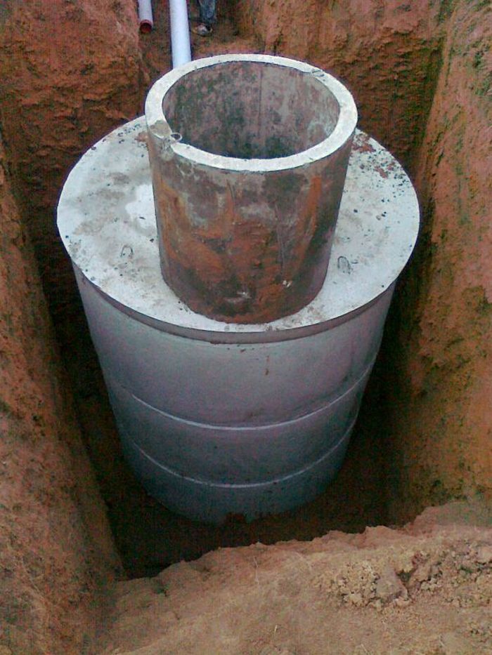 Sewage septic tank concrete ring installation, building manhole using  concrete ring mold Stock Photo - Alamy